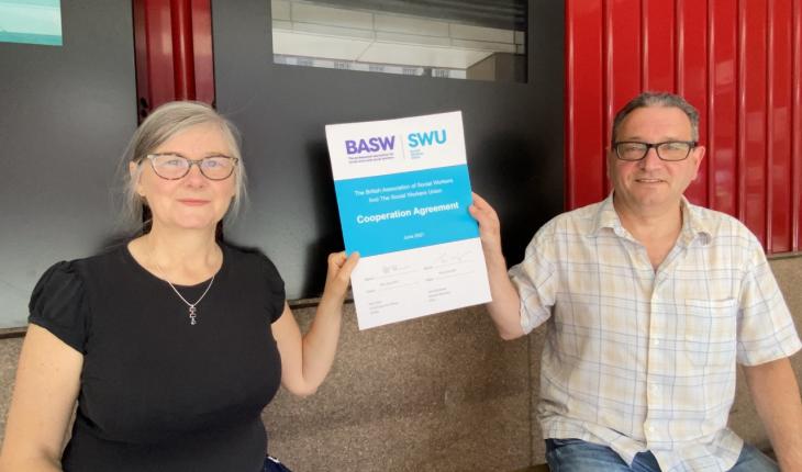 BASW Chief Executive Ruth Allen and SWU General Secretary John McGowan hold up the newly signed Co-operation Agreement.