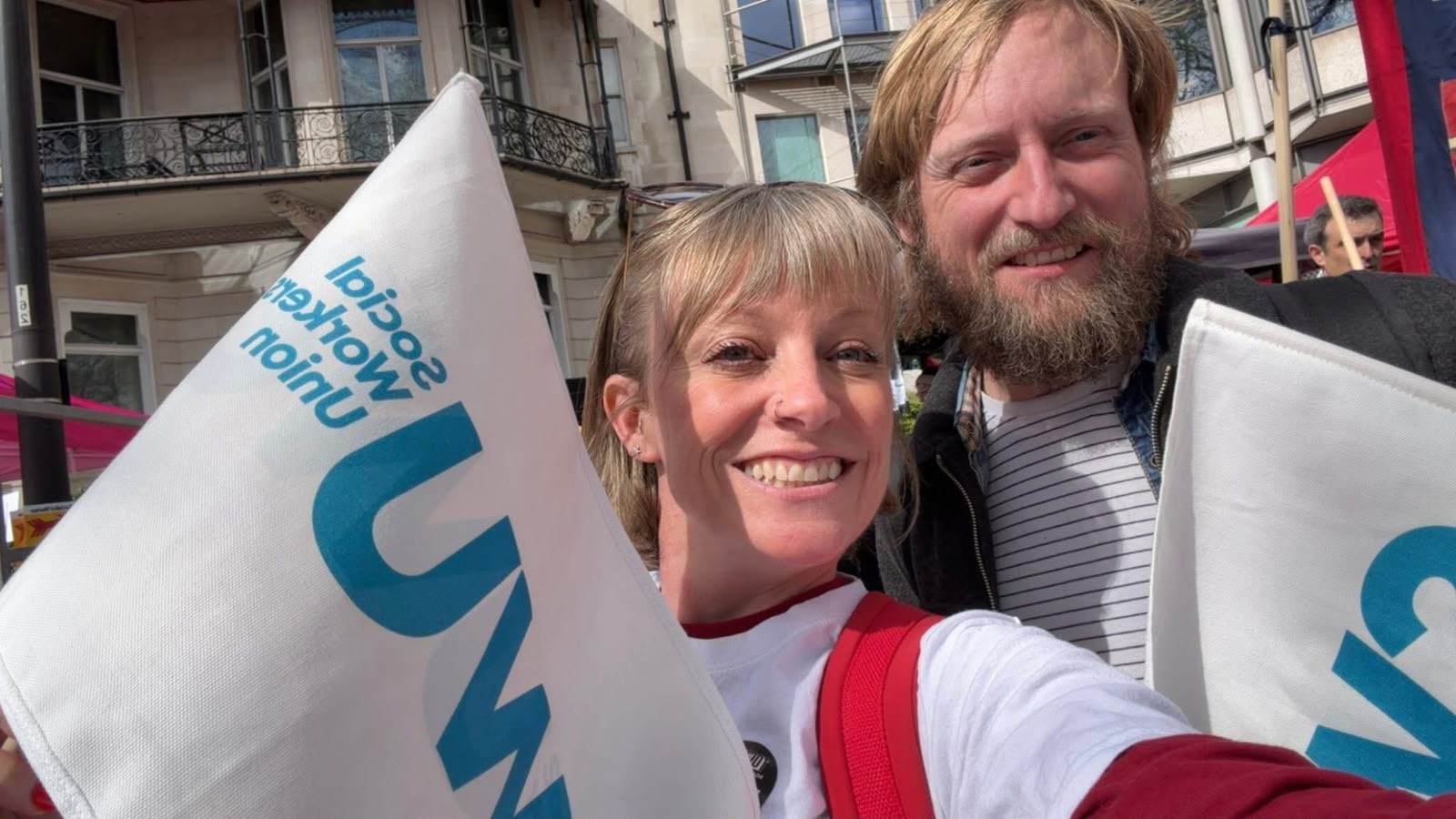 Chrissie Beatty and Dave Callow waving SWU flags at the 28th March 2026 Together march against the far right